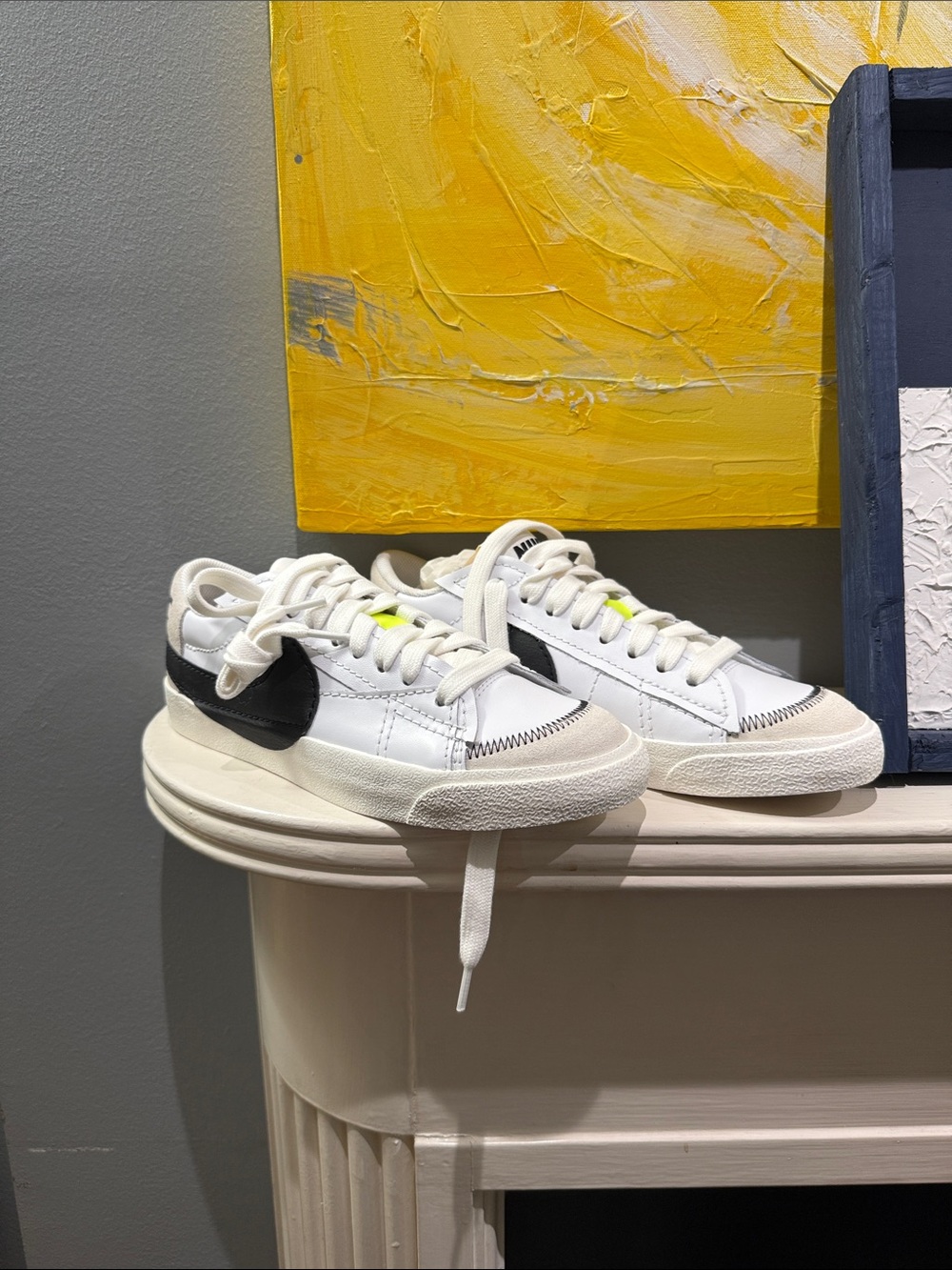 Nike White Low-Top Sneakers with Black Swoosh and Neon Yellow Tongue Tab